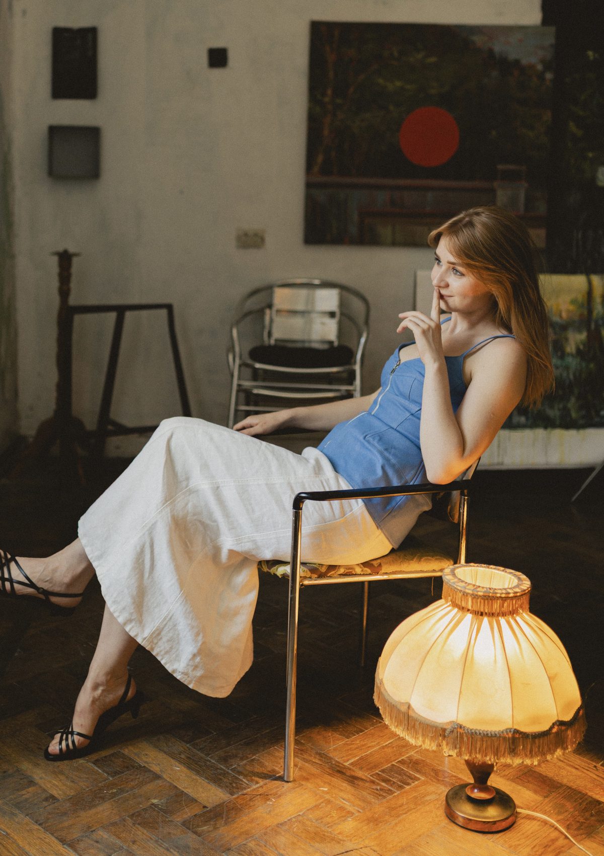 Veronika in an armchair by a lamp